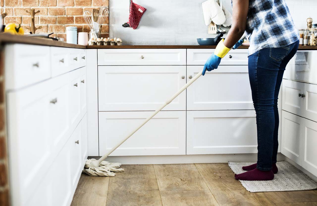Person mopping a kitchen floor